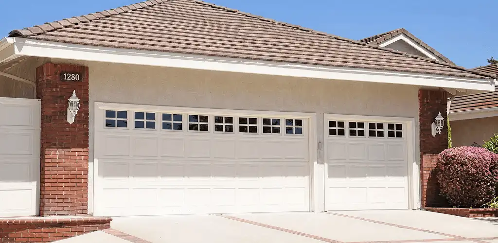 Residential garage door repair service for a double garage door in Lowell, MA