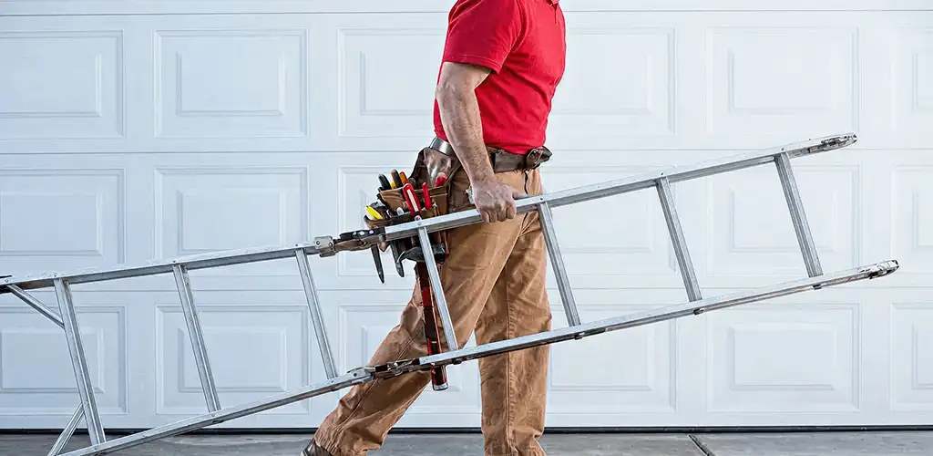 Garage door repair technician arriving with tools and ladder in Lowell, MA